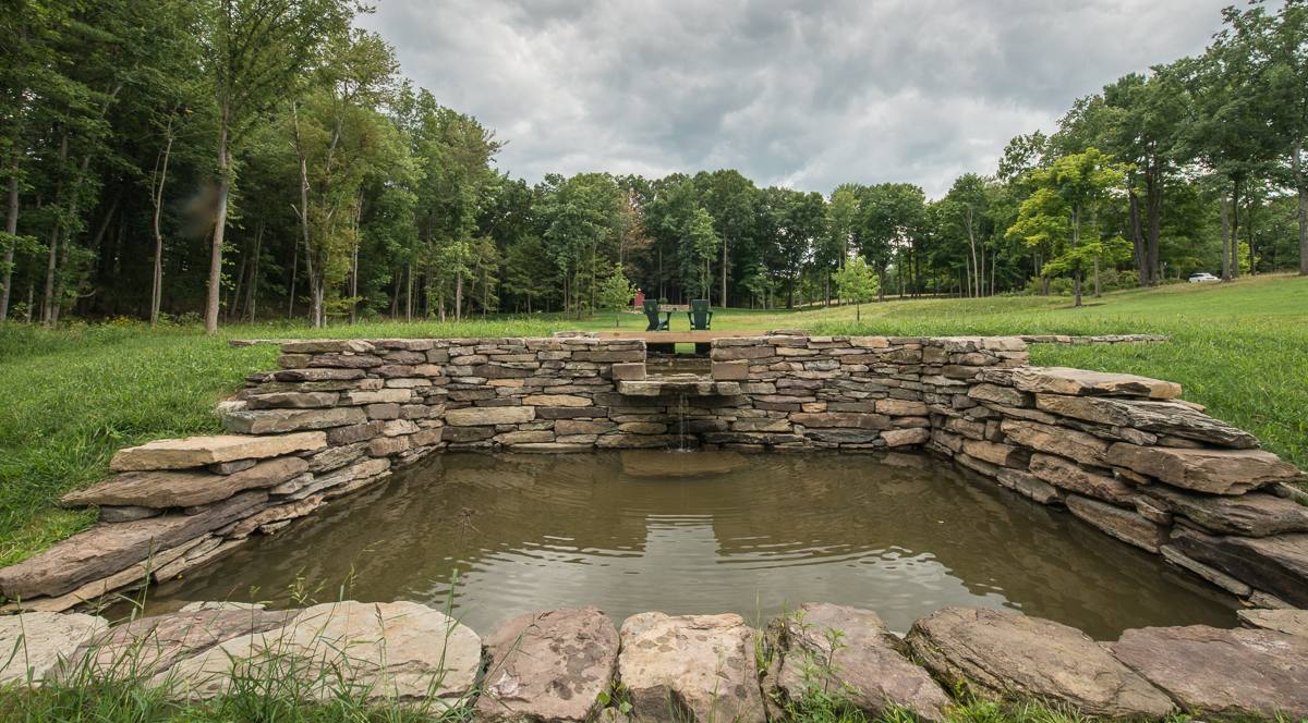 Stone-walled spring pool with a small waterfall