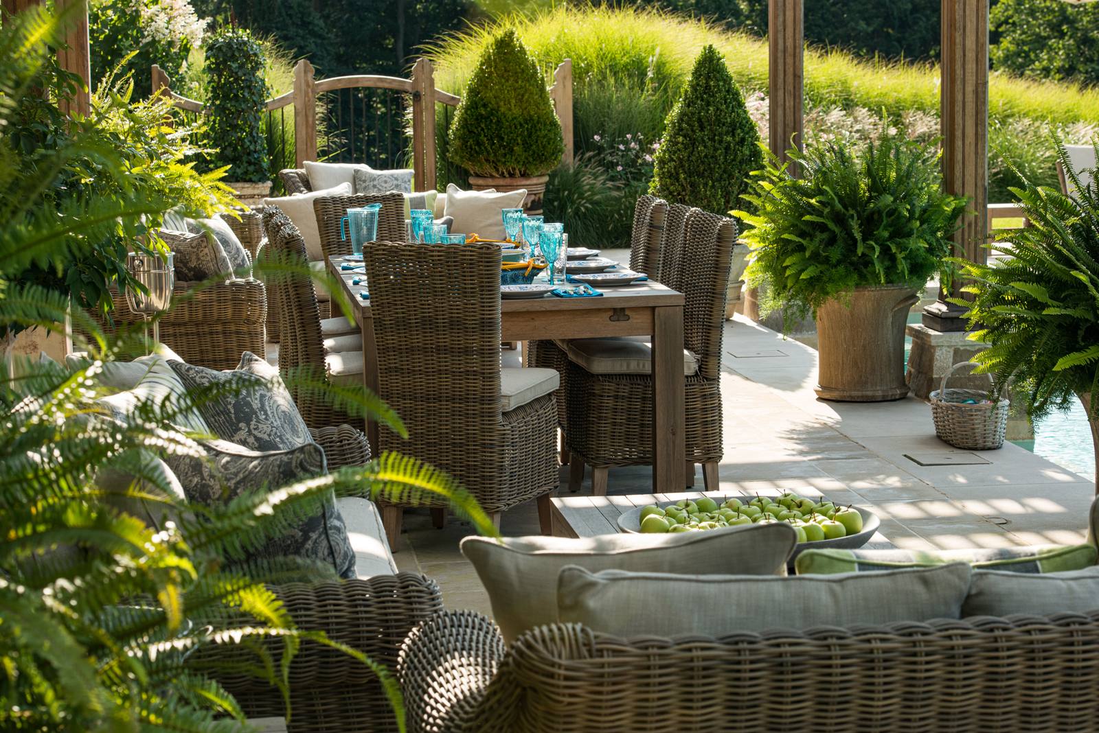 Dining table and lounge seating under the pool pergola