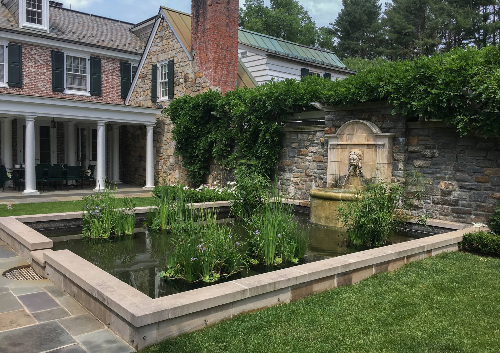 Pond, fountain wall and covered terrace