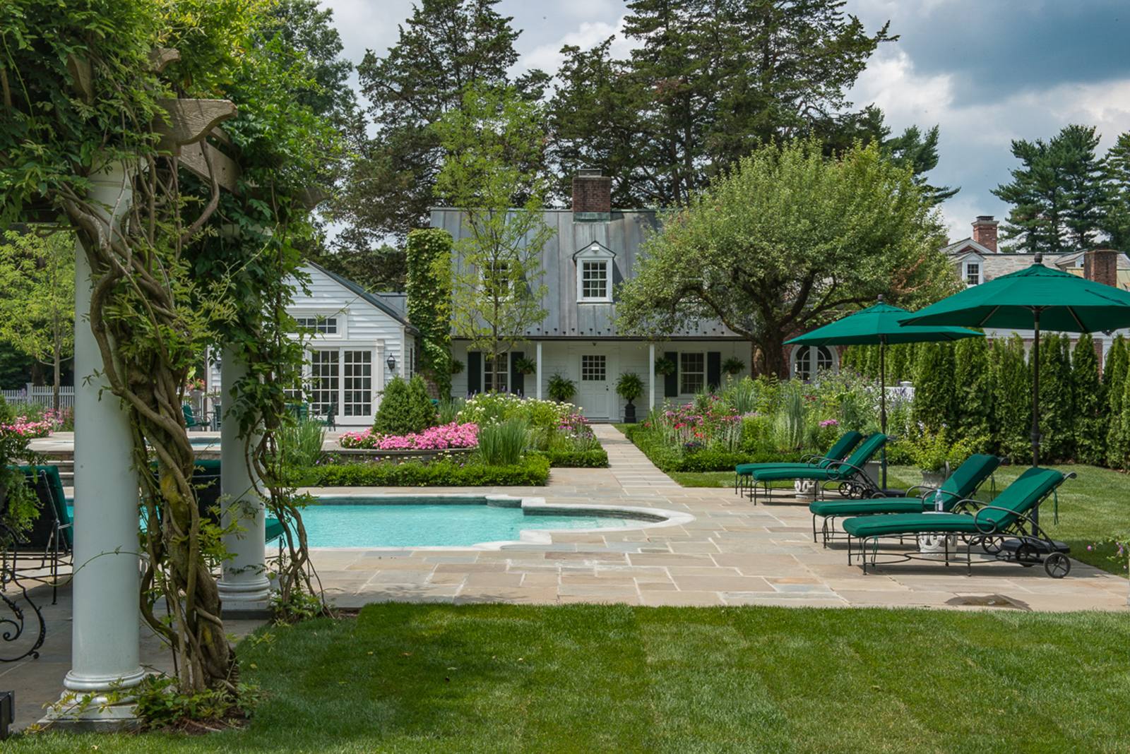 Pool terrace with pergola and flower borders