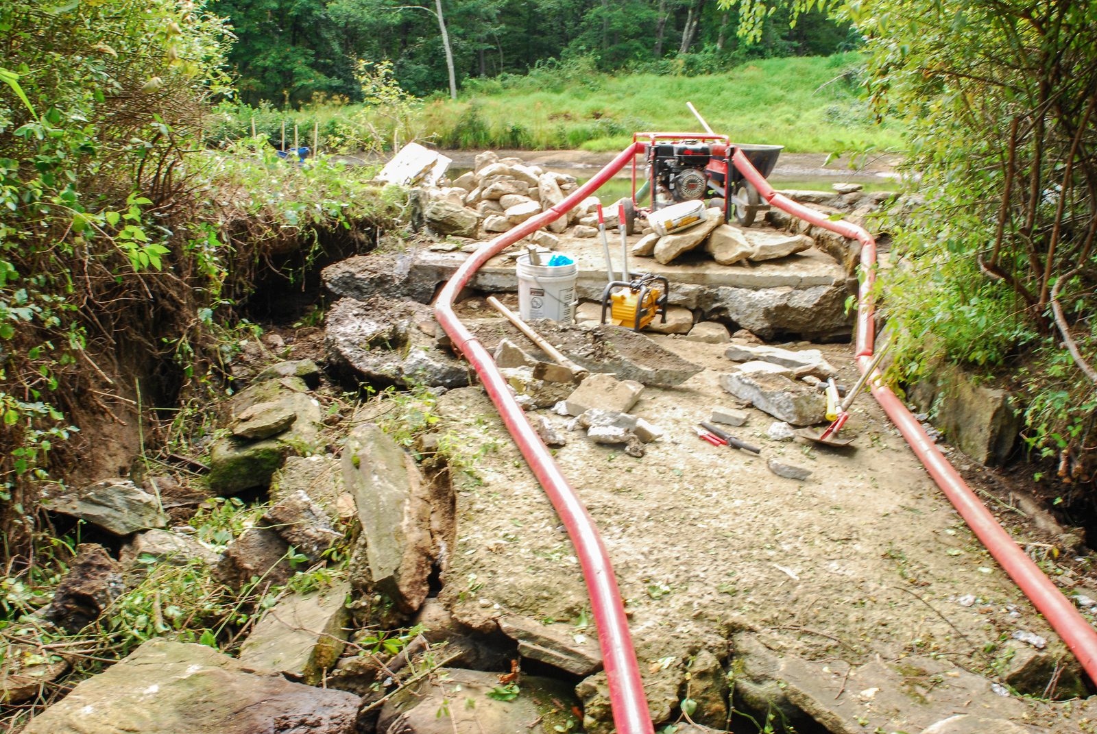 Rebuilding the spring channel with a pump and hoses during construction